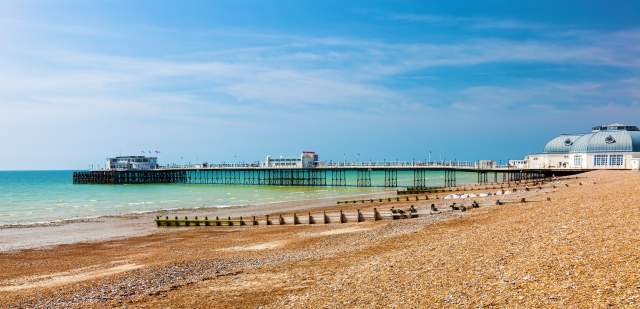 View of the shingle beach and pier at Worthing seafront, sussex