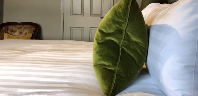 A green colour hotel room with bed at East Beach Guest House, Littlehampton