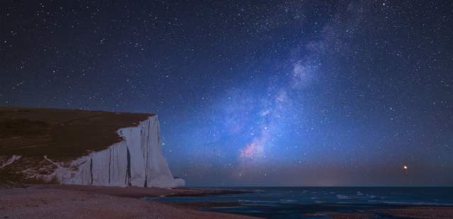 stargazing - milkyway visible at night in a dark skie over seven sisters cliffs