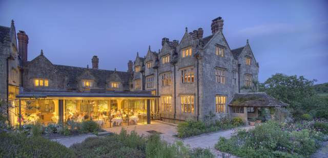 External view of Graveytye Manor and restaurant from the gardens, taken in the evening