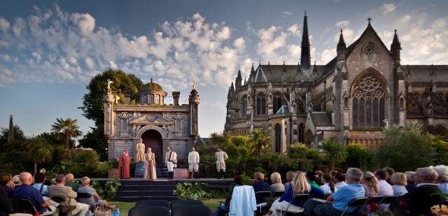 Audience watching Midsummer Shakespeare outdoor theatre performance in grounds of Arundel Castle
