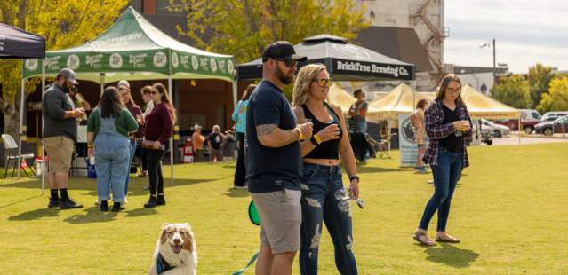Couple with dog in park at an event