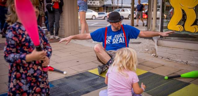Magician playing with kids at Buskers' Bash
