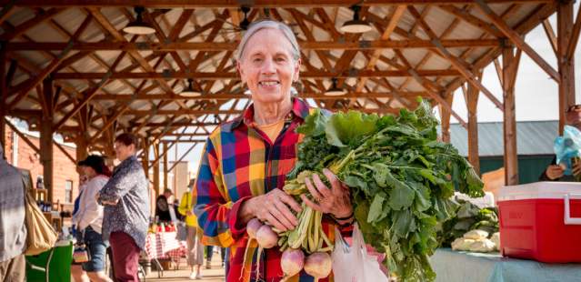 Man holding vegetables at Farmers Market