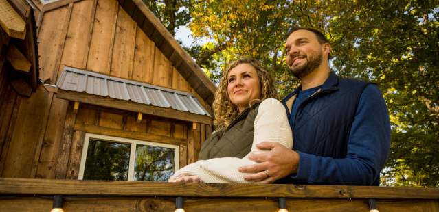 Couple on porch of treehouse AirBNB