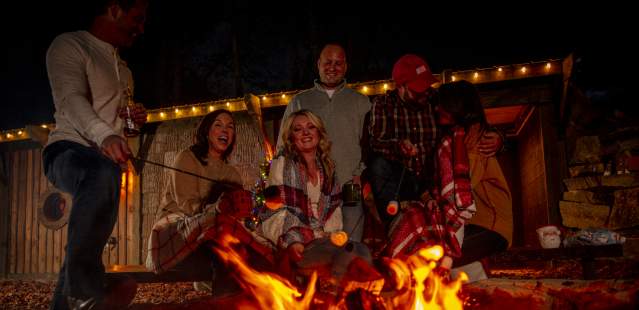 Group of friends around fire at the Cherry Treesort