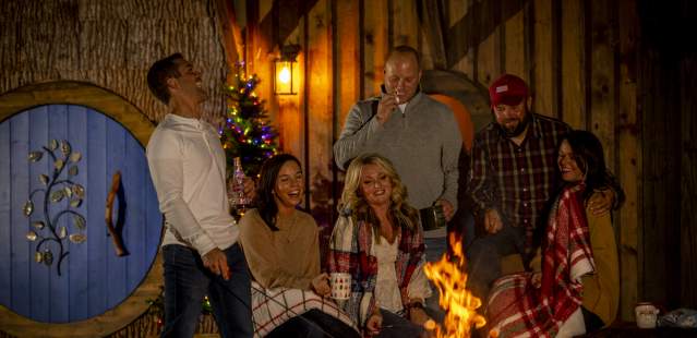 Friends and family around bonfire at Christmas
