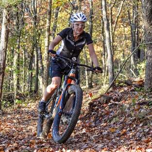Woman mountain biking in the fall