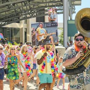 Second line parade featuring people with instruments and signs