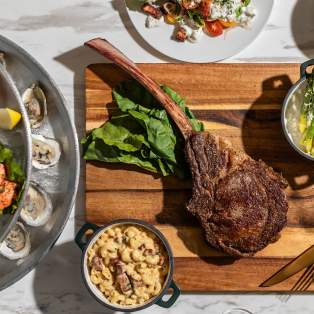 Overhead shot of meat and vegetables on a cutting board at Le Moyne's Chophouse in Mobile, AL things to eat