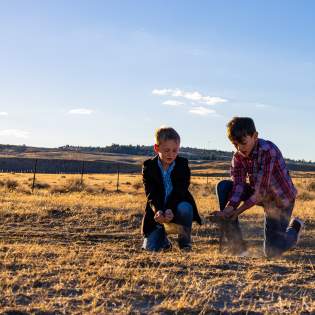 Historic Trails West - kids touching the dirt on the Oregon Trail