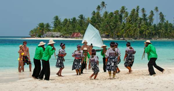 Guna Dule community performing a traditional dance on a beach in San Blas, Panama
