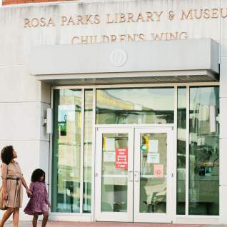 Mom and daughter in front of Rosa Parks Museum