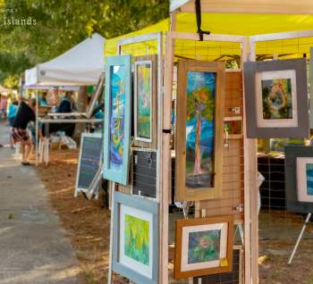 paintings for sale at an outdoor festival