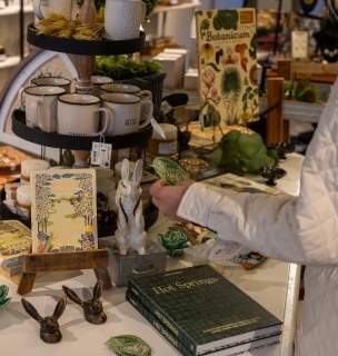 person shopping merchandise table inside whim and wise store in downtown rapid city, sd