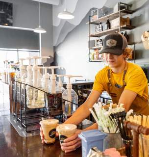barista setting down coffees on counter at grounded coffee co in Rapid City, sd