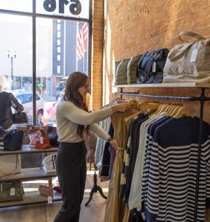 person shopping the clothing rack of byrch boutique in downtown rapid city, sd