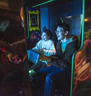 kids playing arcade games at press start in downtown rapid city, sd