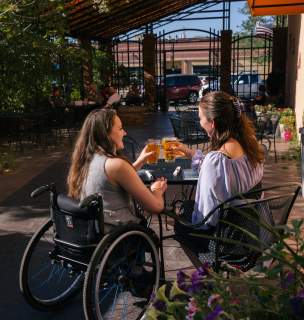 Two women touching beer glasses at Thirstys in Rapid City South Dakota