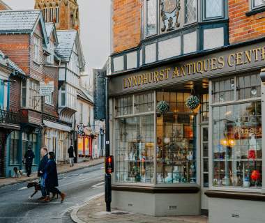 People walking on Lyndhurst high street outside the Antiques Shop in the New Forest