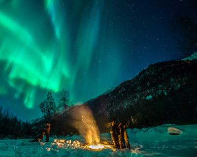Travelers camp out to catch the northern lights near Anchorage.
