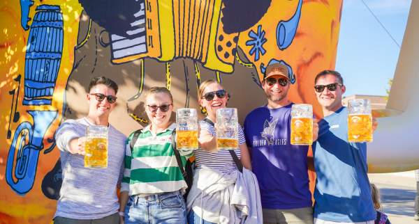 5 friends holding up beer steins at TosaFest