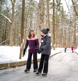 people iceskating on trail in woods