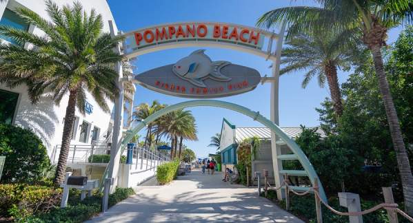 The entrance to the Pompano Beach Pier, on a bright sunny day, in Pompano Beach Florida