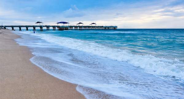Rolling waves on Pompano Beach with the Fisher Family Pier in the distance