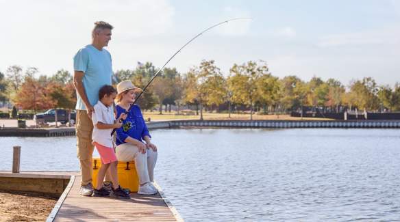 two grandparents fish with their grandson at prien lake park
