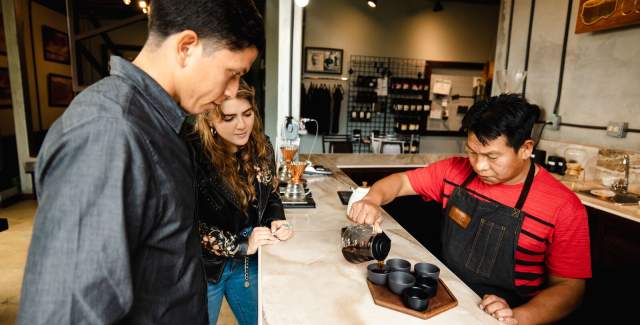 Couple watch attentively as barista pours coffee at the Coffee tasting experience at Elida Estate coffee (Lamastus)