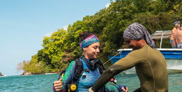 Woman getting ready to dive in Playa Huertas Reef in Portobelo Colon province