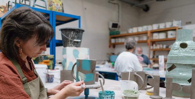 Artist making clay sculpture in a workshop in Sussex