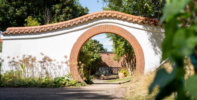 A stone arch in John Dawber Gardens, a community garden in the grounds of The Lawn in Lincoln
