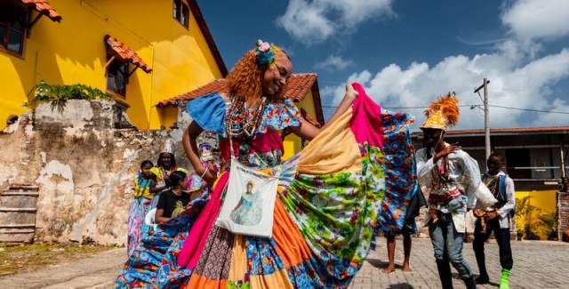 Woman with colorful pollera conga dancing at Portobelo