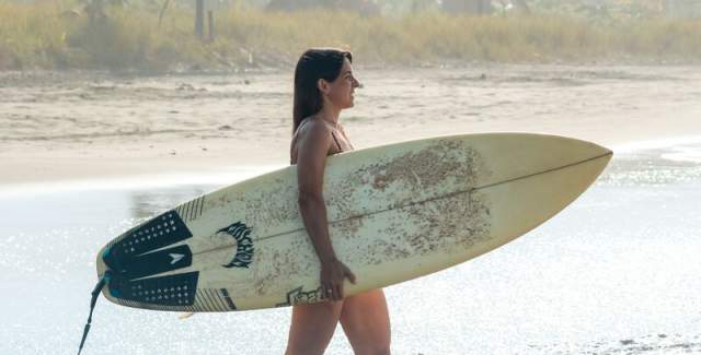 Surfer going into the water at Playa Morrillo
