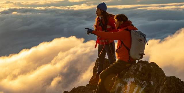 Couple at sunset in the top of Baru Volcano. At the background you can see huge clouds