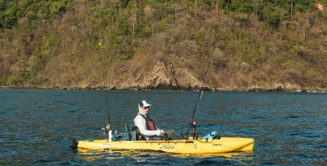 Individuals on a tiny fishing boat.