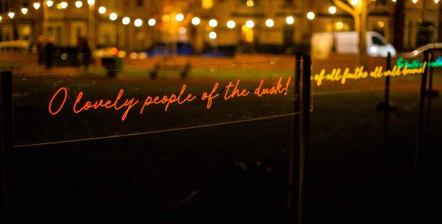 A light installation of glowing handwritten text