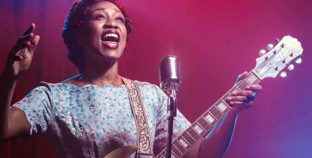 Beverley Knight singing with a guitar in the stage production of Marie and Rosetta