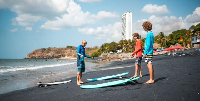Two companions trying their hand at surfing.