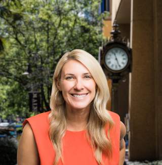 Kelly Barbrey Headshot with city background