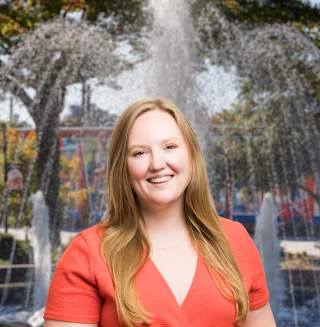 Helen Dennis Headshot with city background