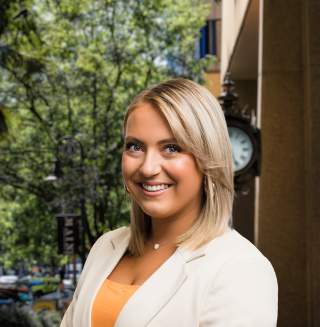 Camille Doloughty Headshot with city background