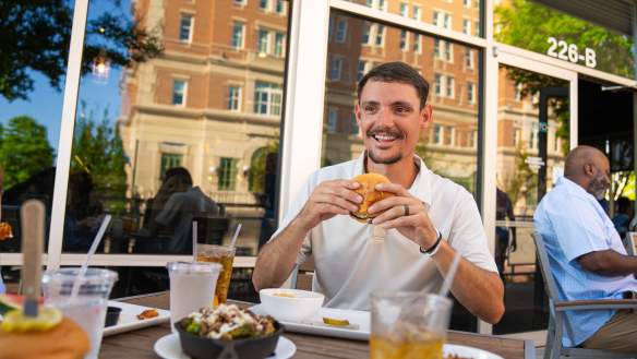 Man eating burger from Cribb's Kitchen