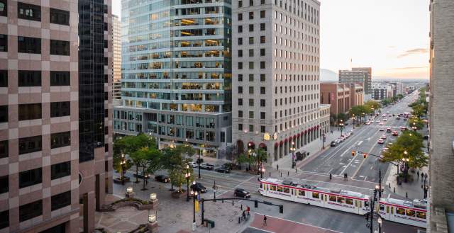 View of Salt Lake City main street with Trax light rail on the street and and early sunset sky