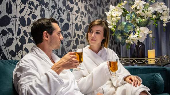 A couple relaxes in robes at the ARIA Medispa, Yoga and Wellness Center