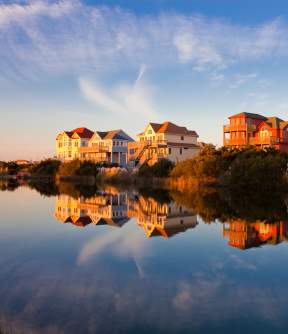 Homes sit on the water's edge, granting their occupants the best Outer Banks sunset views.