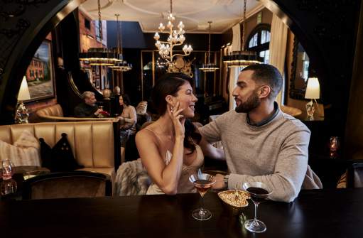 Couple sharing drinks at an eclectic hotel bar