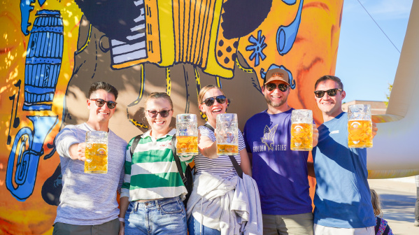 5 friends holding up beer steins at TosaFest